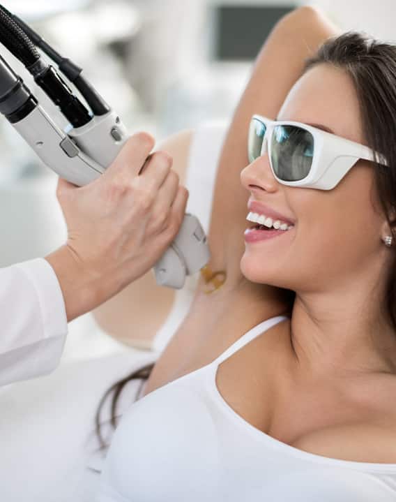 professional at At Regeneris Medspa & Cosmetic Surgery treating woman with laser hair removal